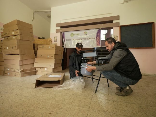 Oxfam staff and partner members deliver folding commodes to shelters in Rafah and Khan Younis, Gaza. With water and sanitation facilities and scarce, these commodes help prevent the spread of disease.