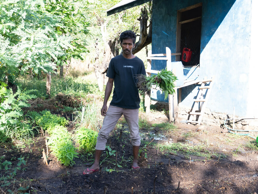 Mekko, Indonesia: Said (33) in front of his Kangkong plantation, which he has planted to adapt to climate change and the reduction of fish stock in the ocean. Photo: Vikram Sombu/Oxfam