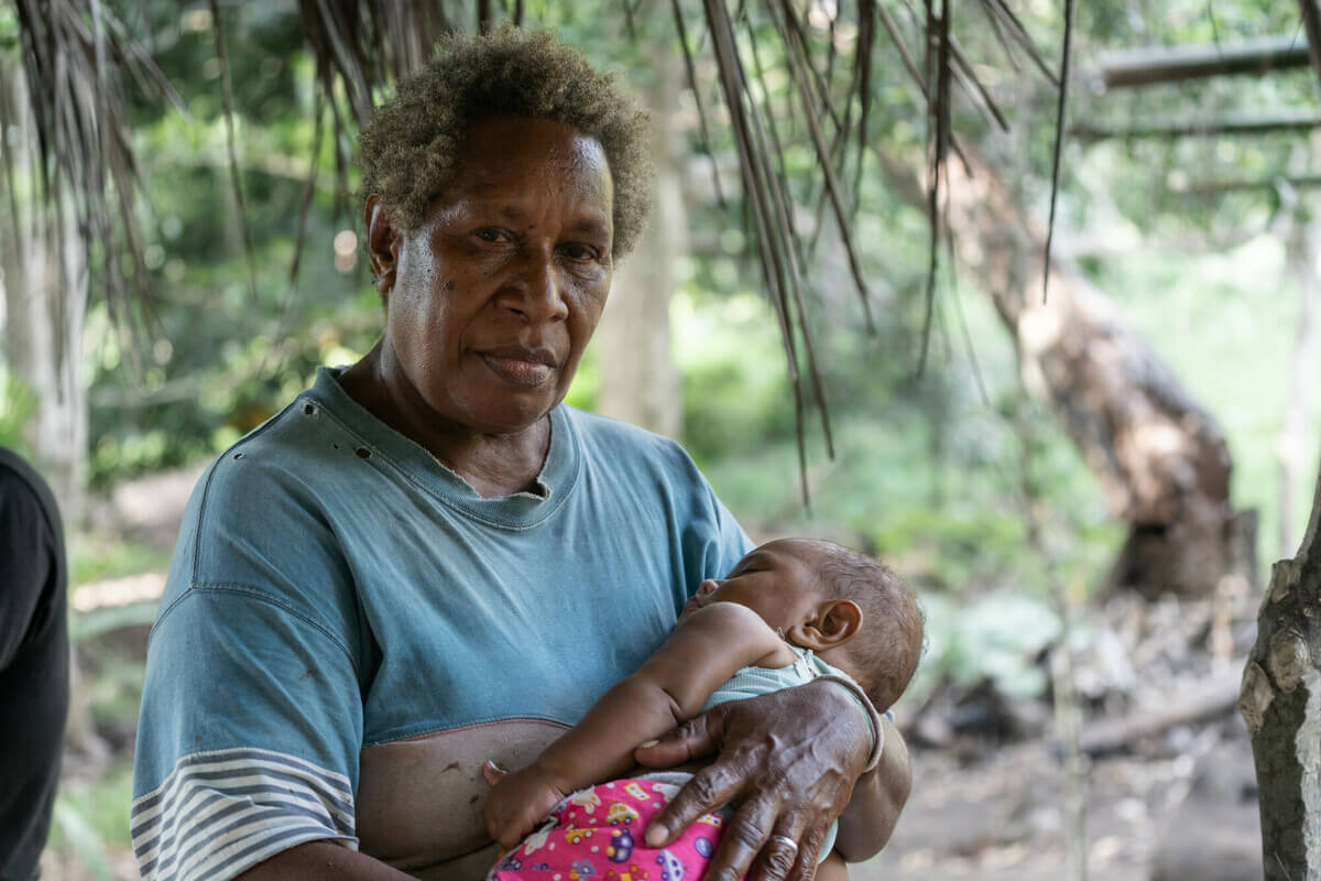 Molpoe, Vanuatu: Pamela with one of her grandchildren. Her home, the village of Molpoe in Vanuatu, was hit by a devastating landslide caused by torrential rain, which has become more frequent due to extreme weather. Photo: Ivan Utahenua/Oxfam Molpoe, Vanuatu: Pamela with one of her grandchildren. Her home, the village of Molpoe in Vanuatu, was hit by a devastating landslide caused by torrential rain, which has become more frequent due to extreme weather. Photo: Ivan Utahenua/Oxfam