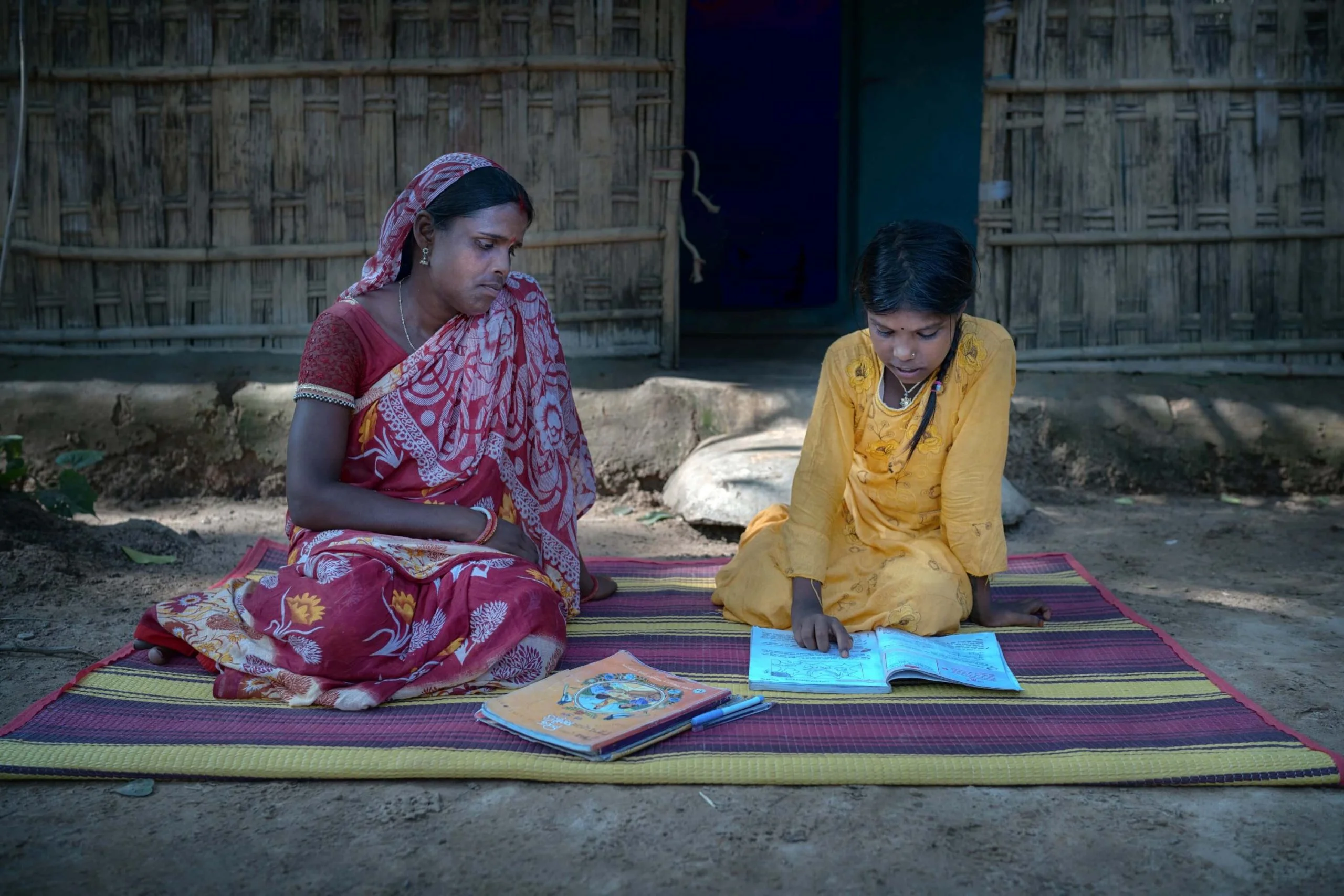 Bangladesh: Munni with her daughter. Munni is a tea garden worker and earns just 170 Taka [AU$2.30] per day. She has to take out loans in order to buy groceries and then struggles to pay these loans back. Munni attended training run by Oxfam partner organisation, Breaking the Silence, and says she has gained courage through this training. Photo: Fabeha Monir/Oxfam