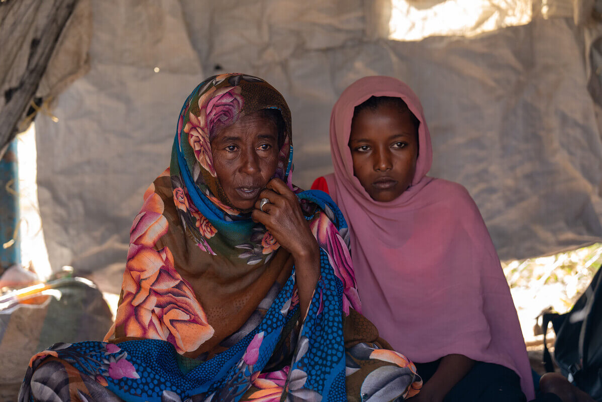 South Sudan: Asia Ahmed* with her mother, Suat, at their home in Renk, South Sudan. They are among nearly a million people displaced by the ongoing conflict in Sudan. Photo: Herison Philip Osfaldo/Oxfam South Sudan: Asia Ahmed* with her mother, Suat, at their home in Renk, South Sudan. They are among nearly a million people displaced by the ongoing conflict in Sudan. Photo: Herison Philip Osfaldo/Oxfam