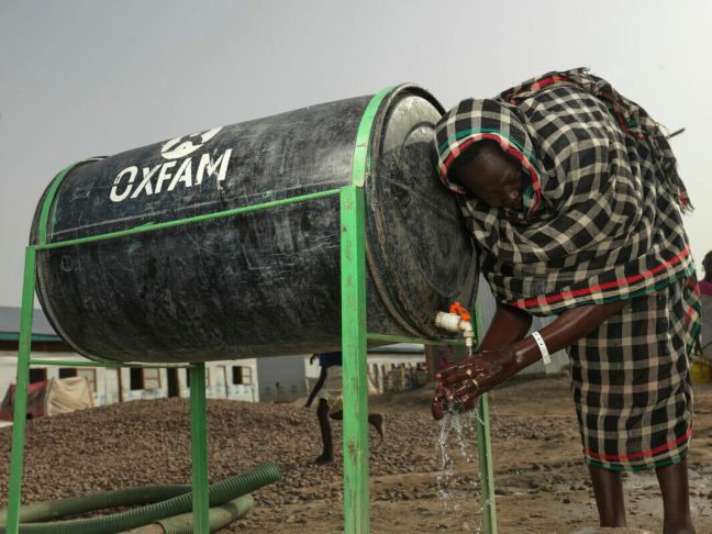 South Sudan: Achol Ring Tong Longar, 21, washing her hands after arriving at the South Sudan border from war torn Sudan. Photo: Peter Caton/Oxfam