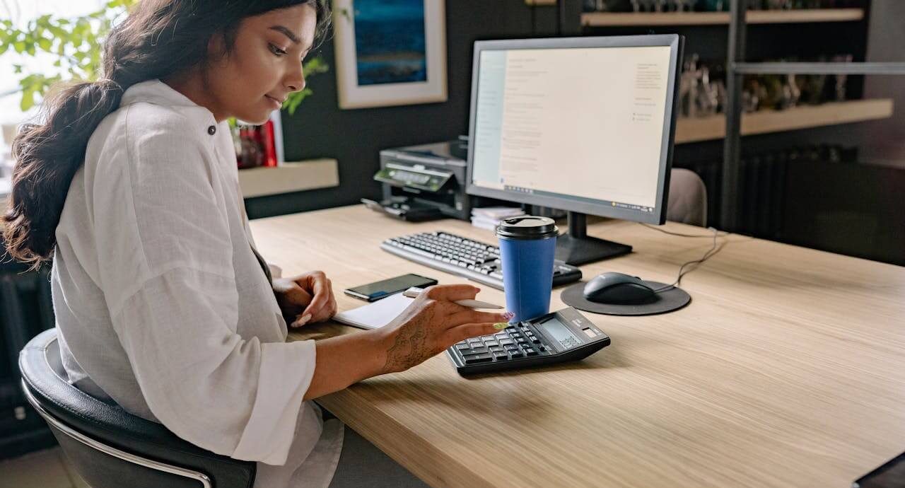 A person using a calculator while doing their taxes. Photo: Yan Krukau/Pexels