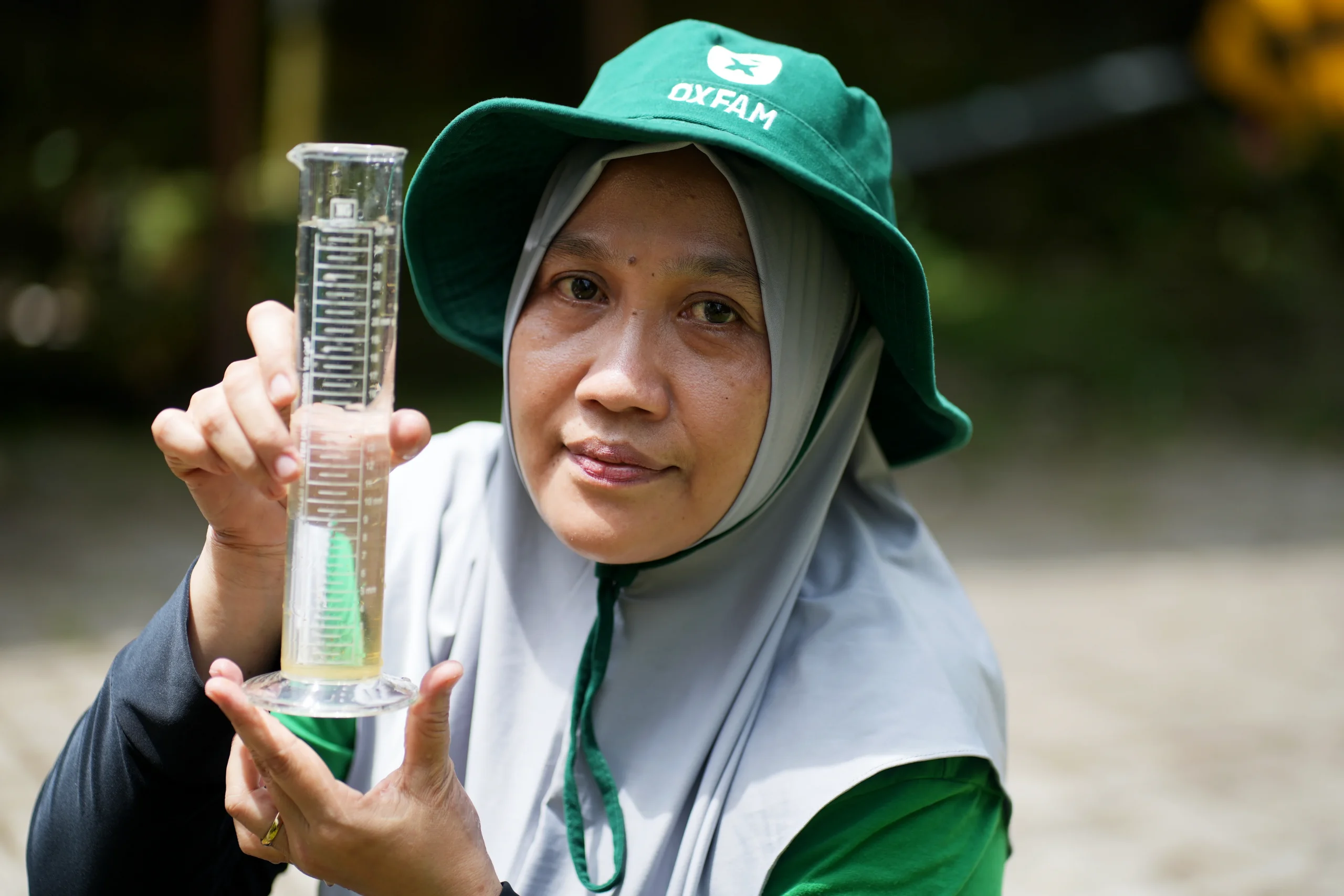 Lombok, Indonesia: As part of her community's anticipatory action response, Mariani operates the ombrometer and documents water levels in her village every day. Photo: Aimee Han/Oxfam