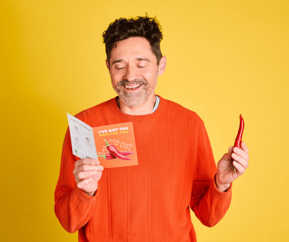 Australia: Sam holds an Oxfam Unwrapped card and a chili. Photo: Michelle Jarni